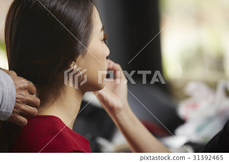 a woman is applied make-up on her eyes. a woman is applied make-up on her eyes. 31392465