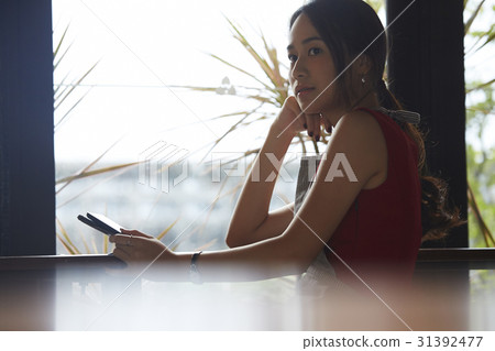 a woman is thinking something near by a window. a woman is thinking something near by a window. 31392477