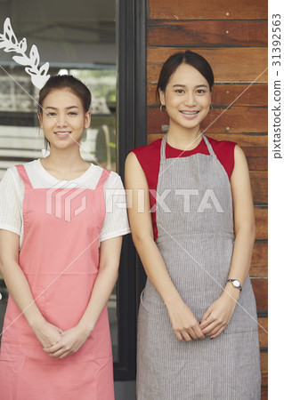 Portrait of pretty waitresses smiling in a coffee shop. Portrait of pretty waitresses smiling in a coffee shop. 31392563