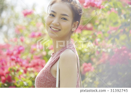 Happy young woman is in a garden 31392745