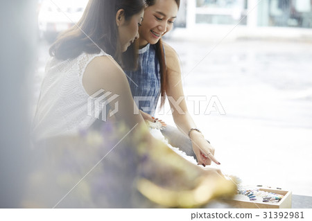 Two girls are happily choosing fingertips Two girls are happily choosing fingertips 31392981