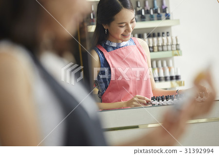 A young happy woman is in a counter of the nail salon A young happy woman is in a counter of the nail salon 31392994