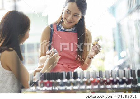 a happy girl is asking the female seller about some lacquer a happy girl is asking the female seller about some lacquer 31393011