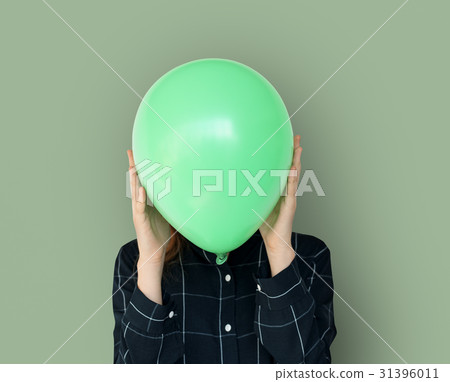 Woman close up holding balloon and posing for photoshoot 31396011