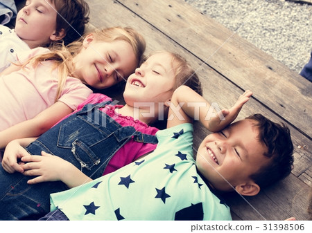 Diverse Little Kids Lay on the Wooden Floor Together Diverse Little Kids Lay on the Wooden Floor Together 31398506