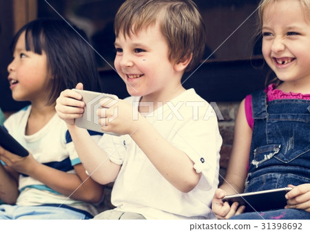 Group of Diverse Kids Using Mobile Phone Device Together Group of Diverse Kids Using Mobile Phone Device Together 31398692