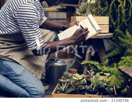 Adult Man Checking Plants Outside Flower Shop Adult Man Checking Plants Outside Flower Shop 31398706