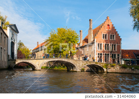 Water canal with old bridge and medieval houses at 31404060