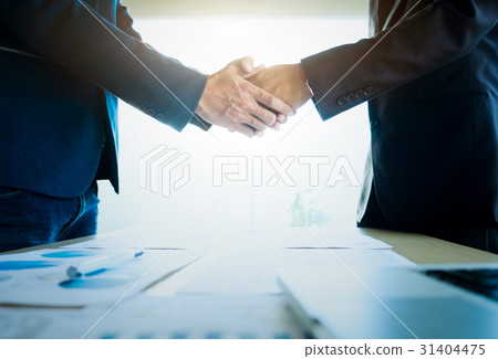 Businessmen shaking hands during a meeting. 31404475