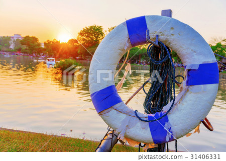Life buoy with lake and sunset Life buoy with lake and sunset 31406331