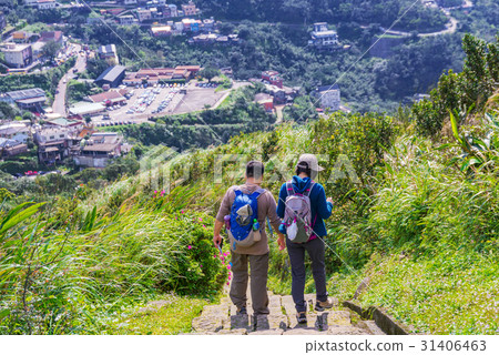 Couple walking down a mountain path Couple walking down a mountain path 31406463