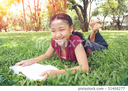 Young cute girl reading a book 31408277