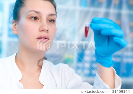 Woman technician with multipipette in genetic Woman technician with multipipette in genetic 31409344