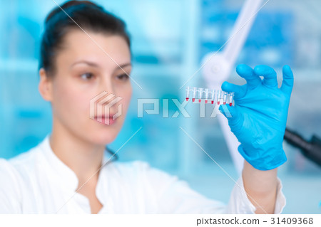 Woman technician with multipipette Woman technician with multipipette 31409368