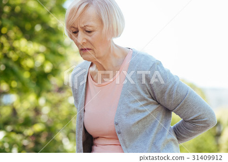 Frustrated pensioner suffering from pain in the Frustrated pensioner suffering from pain in the 31409912