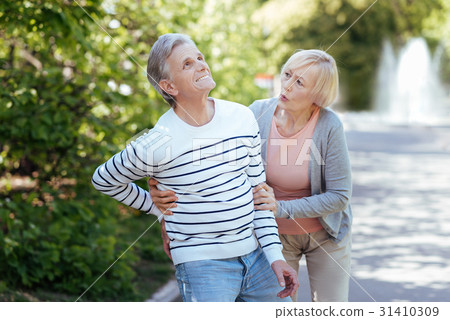 Caring aging woman taking care of ill pensioner 31410309