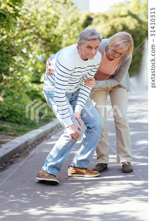 Puzzled pensioner feeling pain in the knee Puzzled pensioner feeling pain in the knee 31410315