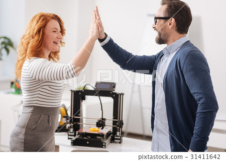 Joyful delighted colleagues giving each other high 31411642