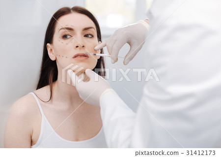 Young motivated woman wanting her lips looking Young motivated woman wanting her lips looking 31412173