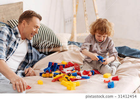 Funny child playing with new meccano 31412454