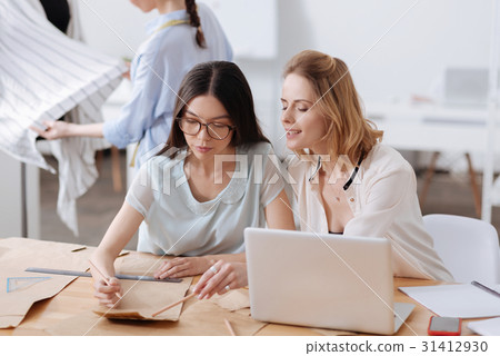 Beautiful blonde giving advice to her colleague 31412930