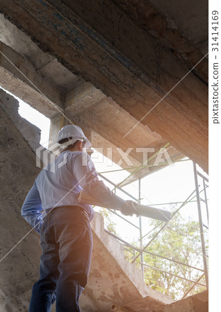 Engineer with blueprint in building site Engineer with blueprint in building site 31414169