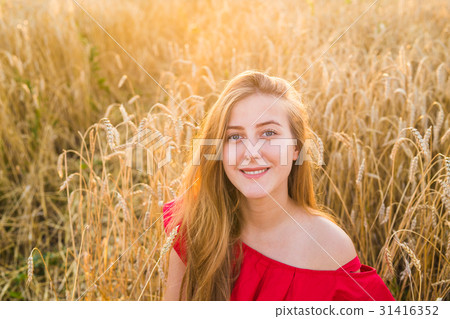 Portrait of a young woman in red dress on a Portrait of a young woman in red dress on a 31416352
