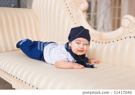 Adorable baby boy in white sunny bedroom. Newborn Adorable baby boy in white sunny bedroom. Newborn 31417040