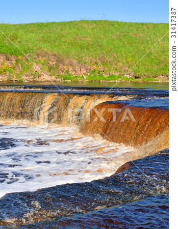 Small waterfall at sunny day. Small waterfall at sunny day. 31417387