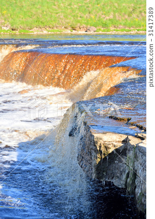 Small waterfall at sunny day. Small waterfall at sunny day. 31417389