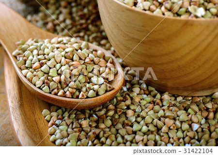Buckwheat in wood bowl on table 31422104