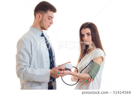 young doctor takes a woman in uniform pressure young doctor takes a woman in uniform pressure 31424569