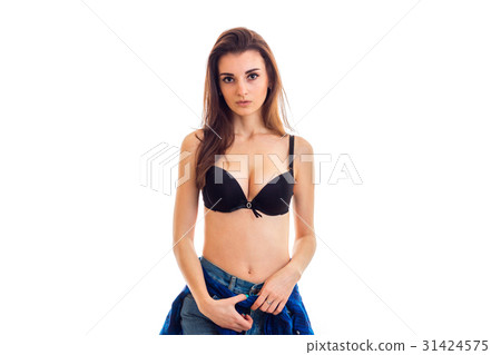 beautiful young brunette stands in the Studio in a beautiful young brunette stands in the Studio in a 31424575