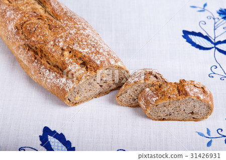 Fresh cereal baguette on white cloth 31426931