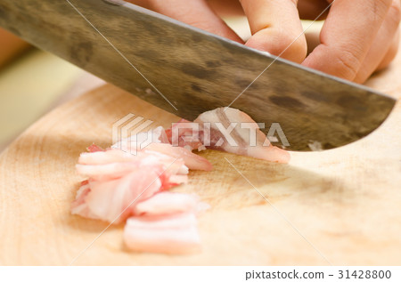 Chef slice streaky pork on wooden board Chef slice streaky pork on wooden board 31428800
