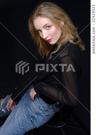 Sexy beautiful woman in jeans sitting on highchair Sexy beautiful woman in jeans sitting on highchair 31429325