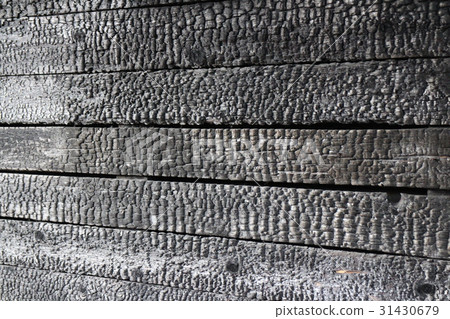 Charred wooden wall after fire arson 31430679