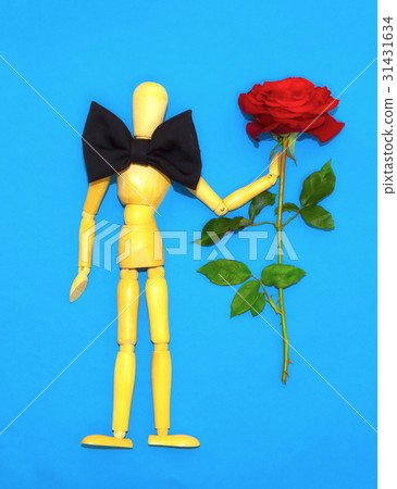 Red rose and wooden man on blue background Red rose and wooden man on blue background 31431634