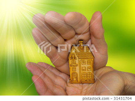 bright picture of man holding wooden house 31431704
