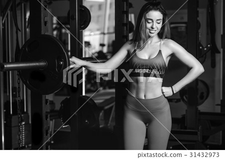 Girl execute exercise with barbell 31432973