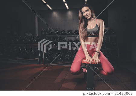 Girl execute exercise with dumbbells . Girl execute exercise with dumbbells . 31433002