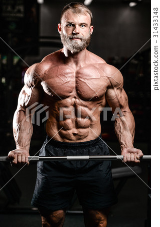 Handsome power athletic man on diet training pumping up muscles 31433148