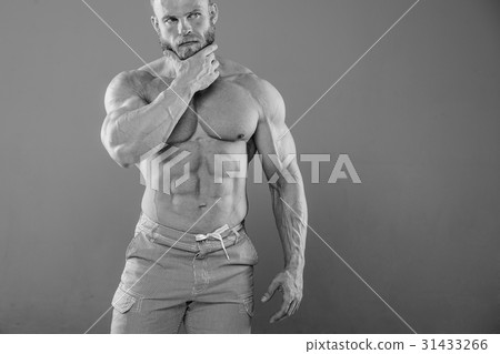 brutal muscular man in studio on gray background fitness model brutal muscular man in studio on gray background fitness model 31433266