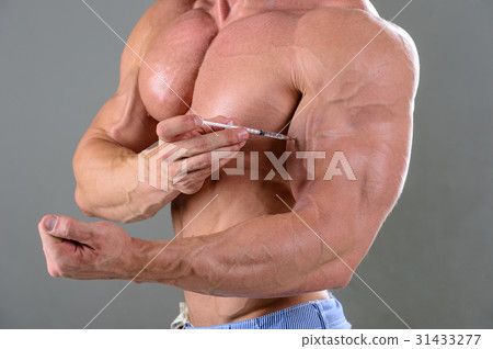 brutal muscular man in studio on gray background fitness model brutal muscular man in studio on gray background fitness model 31433277
