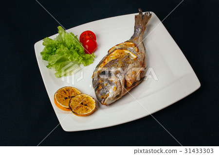 Grilled dorada fish with lemon and spinach Grilled dorada fish with lemon and spinach 31433303