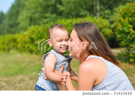 Happy family having fun outdoors. Mother and baby Happy family having fun outdoors. Mother and baby 31433439