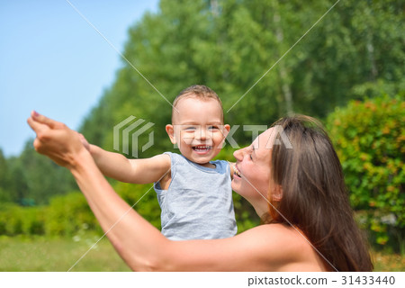Happy family having fun outdoors. Mother and Happy family having fun outdoors. Mother and 31433440