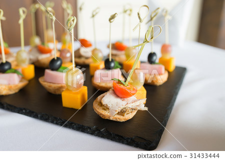 different kind of snaks, small canape with cherry 31433444