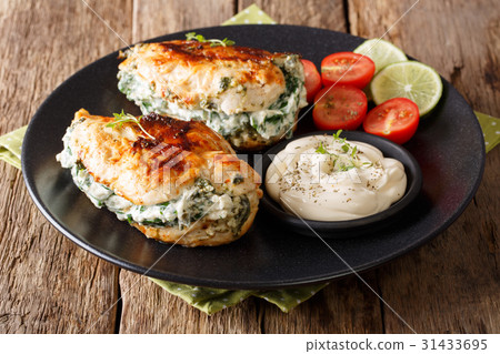 Baked chicken stuffed with cheese and spinach Baked chicken stuffed with cheese and spinach 31433695