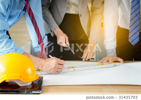 architect engineer meeting and discussing plan 31435703